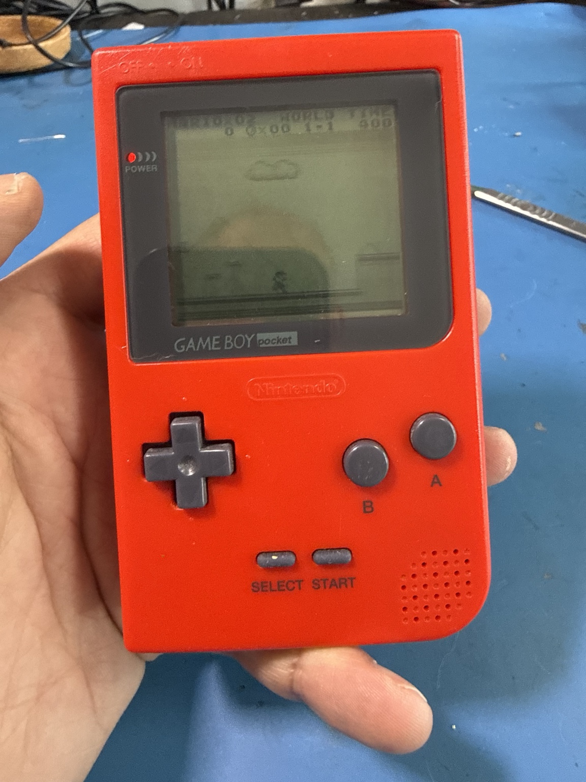 Red Nintendo Game Boy Pocket being tested